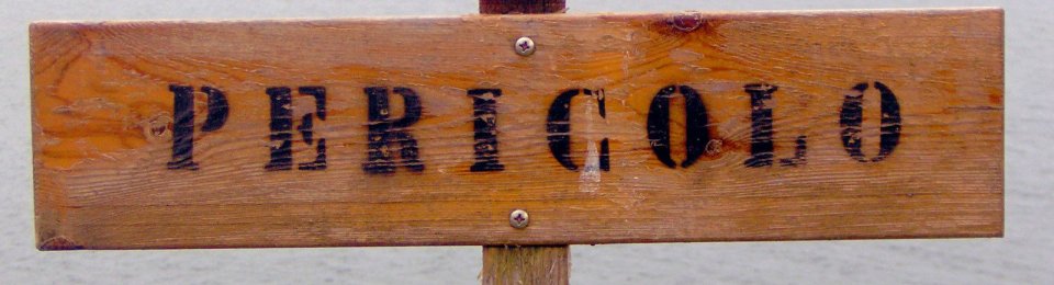 foto cartello in legno con scritta Pericolo